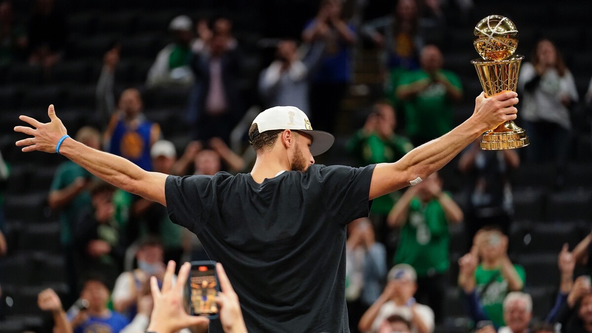 Basketbalista Stephen Curry s cenou pre najužitočnejšieho hráča finále (MVP) oslavuje po výhre nad Bostonom Celtics v šiestom zápase finálovej série NBA. Basketbalisti Golden State Warriors sa stali víťazmi NBA sezóny 2021/2022. (16. júna 2022)