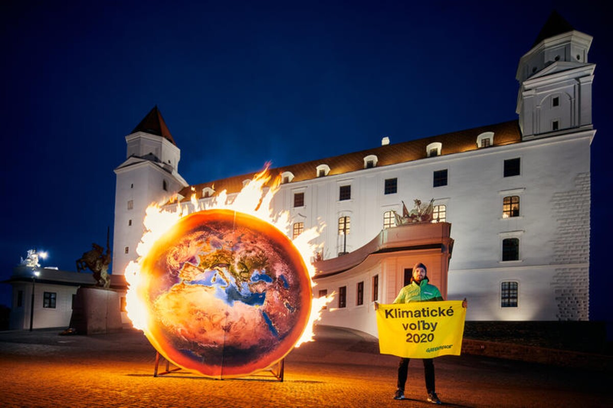 Aktivista Greenpeace Gabriel Švec s planétou v plameňoch.