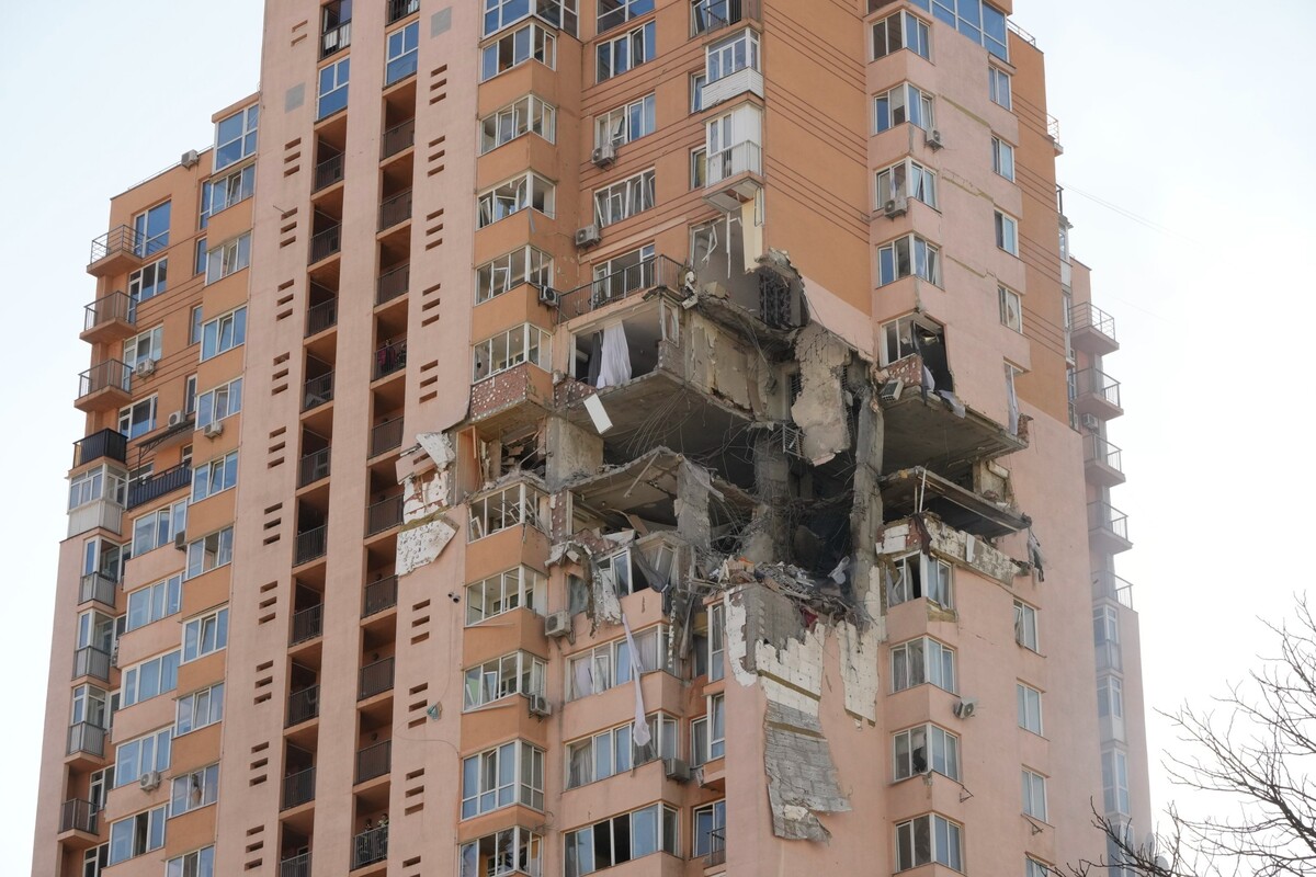 Kyjev –⁠ Na snímku z 26. února 2022 je vidět panelový dům poškozený raketovým útokem.