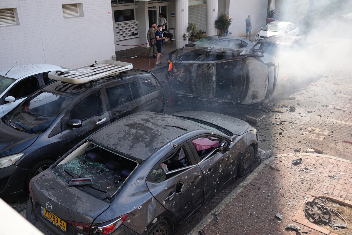 Hořící auta zasažená palestinskou raketou v izraelském městě Aškelon. 