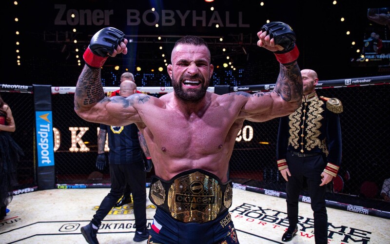 Karlos Vémola prichádza o pás šampióna organizácie Oktagon MMA. Súboj s Ďatelinkom ale prebehne.